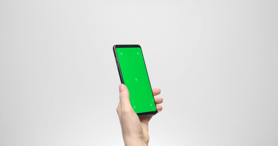 Phone with a green screen in a woman