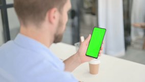 Young Creative Man using Smartphone with Chroma Screen 