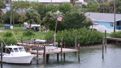 Treasure Island, Florida USA - July 6 2021: An American Flag on a boat dock flies in the first winds of Hurricane Elsa to reach the area. 