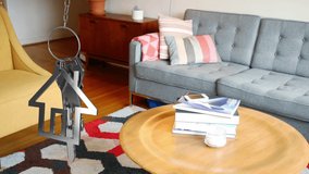 Animation of dangling house key and key fob over living room. new home, property and house ownership concept digitally generated video. - Powered by Shutterstock - Get 15% off with code: PIKWIZARD15