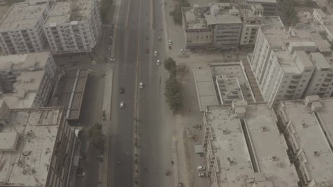 Aerial view of Main Clifton Road in Karachi - Tilt Down - Flat Slog