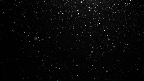 snow falls in winter outside the window at night