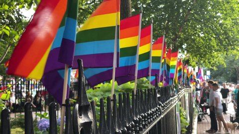 NYC, USA - JUNE 27, 2021: rainbow flags waving on Gay Pride day LGBTQ celebration Christopher Street Park West Village New York City.