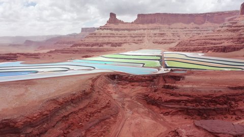 Dead horse point state park aerial 4K footage. Scenic panorama of Potash ponds with salt water from mine in red mountains of Utah. Vibrant colorful salt lakes in red desert landscape with tall cliffs