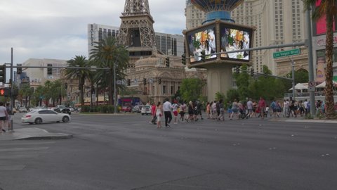 Las Vegas, Nevada - June 7, 2021: Tourist crossing the street on the Las Vegas strip towards the Paris hotel. 