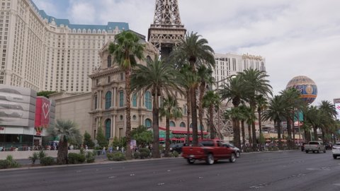 Las Vegas, Nevada - June 7, 2021: Light traffic of cars passing by and the view of the Paris Hotel on the Las Vegas strip. 