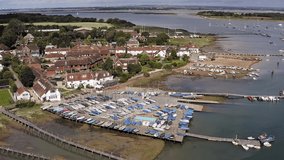 Itchenor in West Sussex situated in a beautiful sailing location with Yachts and Boats at anchor in the estuary, Aerial Footage.