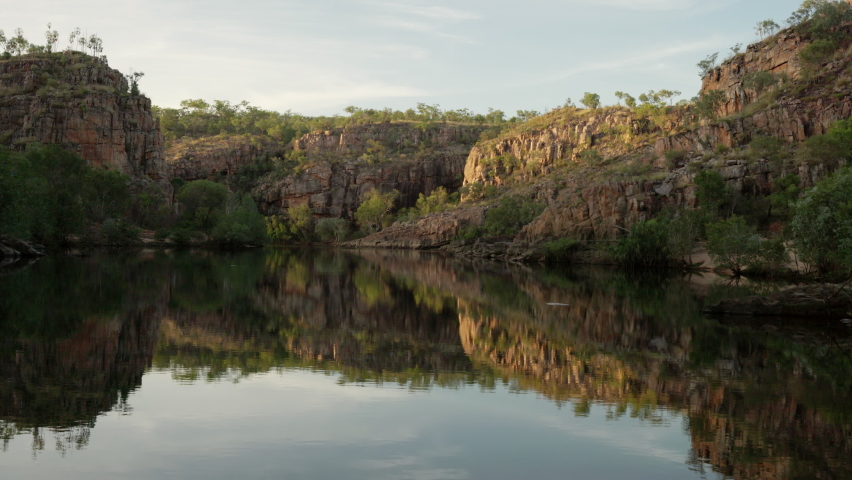 sunrise shot of reflections on the water of nitmiluk-katherine gorge at nitmiluk national park in the northern territory of australia Royalty-Free Stock Footage #1075523405