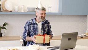 Senior man alone at home having a celebration on a video call