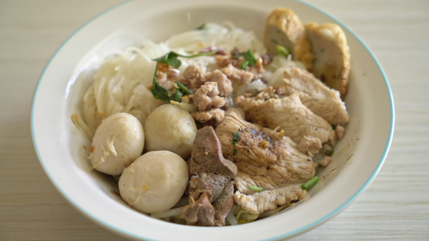 noodles with pork and meatballs in spicy soup or Tom yum noodles in Asian style