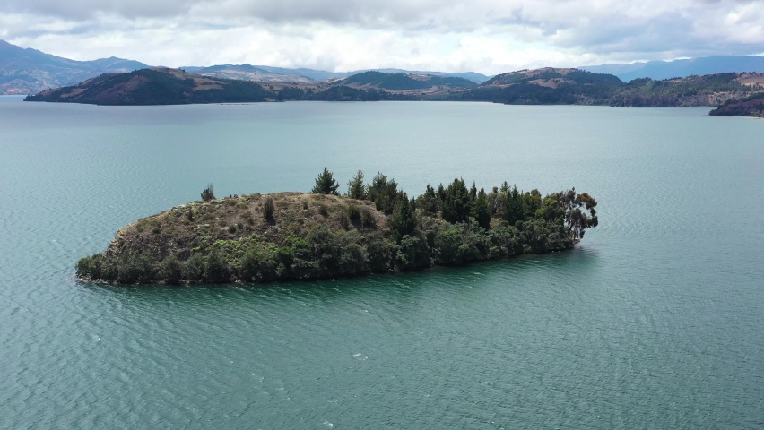Drone Aerial View of Island in Laguna de Tota, Boyaca, Biggest Lake in Colombia. Alpine Water and Highland in Background