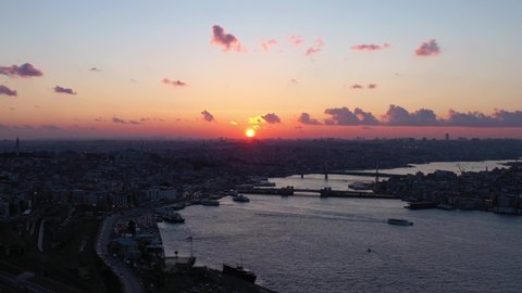 Istanbul City Silhouette at Sunset. Golden Horn Bay and Galata Bridge. Aerial View. Drone Flies Upwards