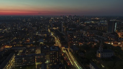 Establishing Aerial View Shot of London UK, United Kingdom, East London at night evening
