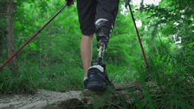 Male hiker with a prosthetic leg. A disabled person overcomes rocks in the forest, enjoying his time on a trip to the mountains, hiking, holding Nordic walking sticks. Metal prosthetic knee and foot. - Powered by Shutterstock - Get 15% off with code: PIKWIZARD15