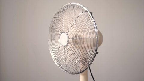 Air fan turning from side to side blowing wind.  Electric fan cooling High heat Temperature Ventilator Cooling the room. Electric Fan-Cooler wings speeding up  until getting to  full speed. concept
