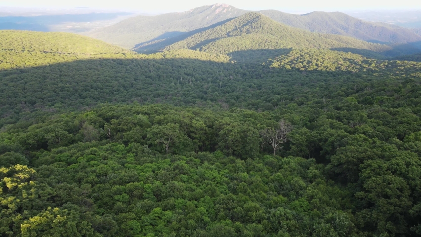 Scenic aerial overview of Shenandoah mountains and hills from above during summer sunset
