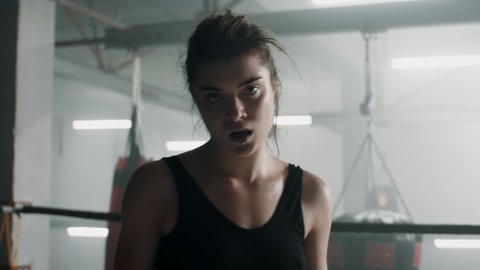 HANDHELD Portrait of Caucasian female boxer posing and looking into camera after the fight. Shot with 2x anamorphic lens