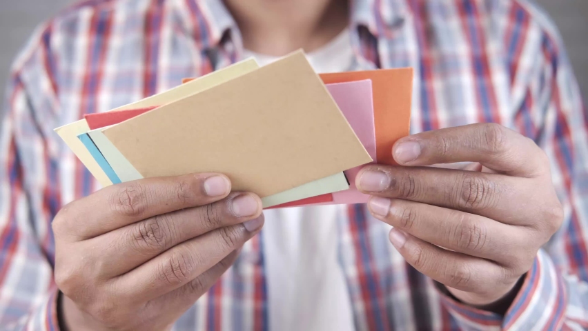 close up of man hand reading a thank you letter 