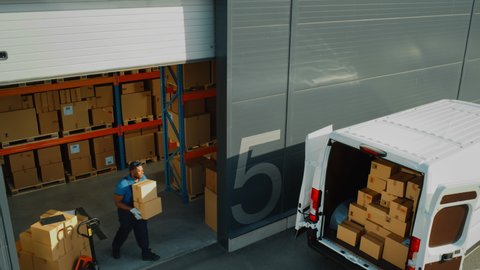 Outside of Logistics Distributions Warehouse with Diverse Team of Professional Workers Loading Delivery Truck with Cardboard Boxes, Online Orders, Purchases, E-Commerce Goods. High Angle Pedestal Shot