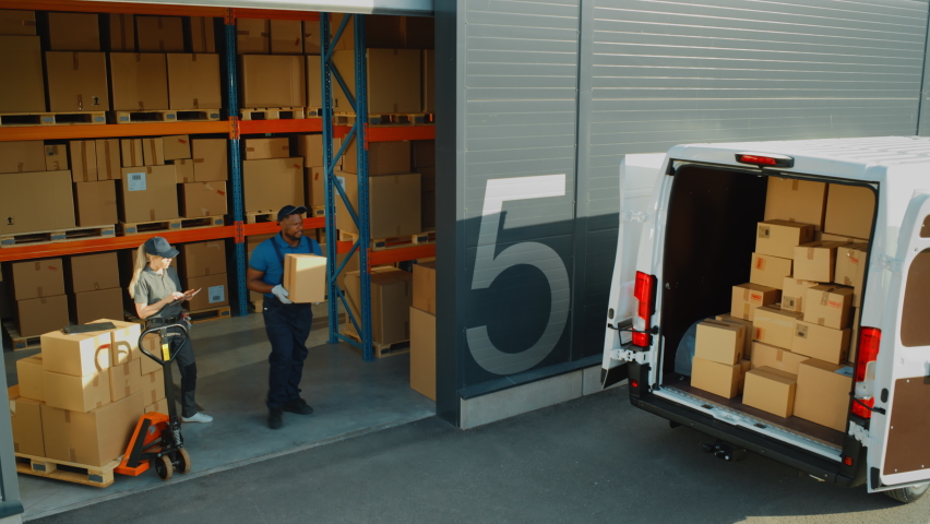 Outside of Logistics Retailer Warehouse With Manager Using Tablet Computer, Workers Start Loading Delivery Truck with Cardboard Boxes. Online Orders, Purchases, E-Commerce Goods. High Angle Shot Royalty-Free Stock Footage #1075562897