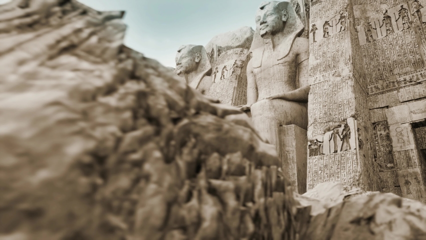 Egyptian temple at karnak with ancient pharaoh statues carved in the mountain | Shutterstock HD Video #1075563431