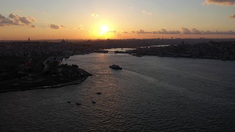 Beyoglu and Fatih Districts of Istanbul City at Sunset. Golden Horn and Galata Bridge. Aerial View. Drone Flies Forward, Tilt Up. Reveal Shot