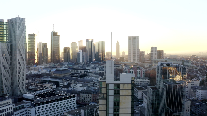 Confident Young Male walking risky on rooftop edge with Skyline of Frankfurt am Main, Germany in background and Beautiful Sunlight, Aerial Wide Drone View Royalty-Free Stock Footage #1075569617
