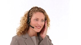 Curly blond haired woman talking on the phone in a call center