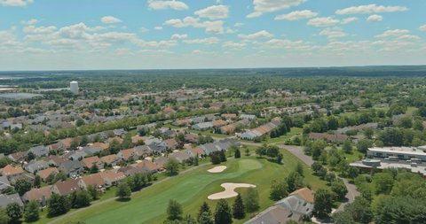 Aerial view of American residential district at suburban development with beautiful Monroe town in landscape the New Jersey