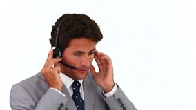 Man in gray suit having a phone call against a white background