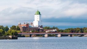 Time-lapse video with movement from left to right. Beautiful view of the Vyborg Castle and the Petrovsky Bridge in cloudy day, Vyborg, Leningrad Oblast, Russia
