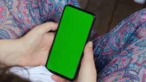 Back View of Woman at Phone with Green Screen for Copy Space. Chromakey Mock Up Without Tracking Markers. 20s Lady Watching Video News Close up. Tap to Click on Centre of Screen