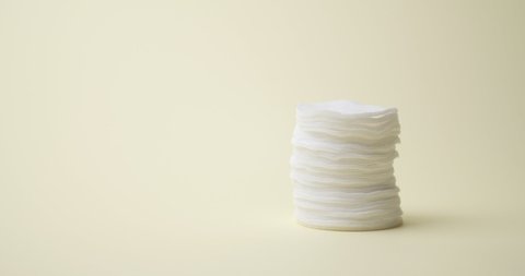 Stack of cotton pads on color background, video with stop motion effect