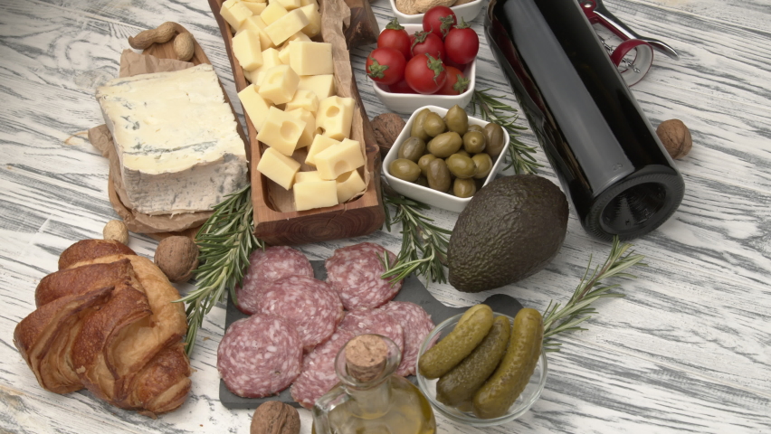 Huge assortment of various tasety spanish, french or italian apertizers. Cheese, meat, olives, stuffed peppers, bread, sticks. View from above. Assortment of spanish tapas or italian antipasti with me Royalty-Free Stock Footage #1075605779