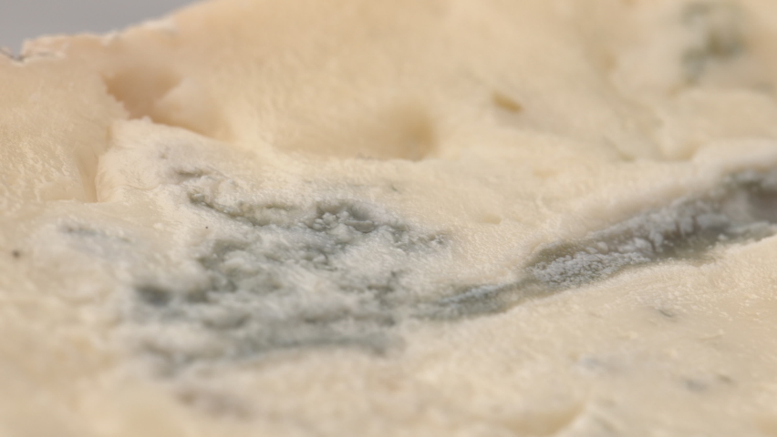 Gorgonzola cheese. Close-up of delicious blue Roquefort cheese. delicious piece of soft brie cheese. Piece of Italian gorgonzola picante. Gorgonzola cheese on wooden board.  Royalty-Free Stock Footage #1075606571