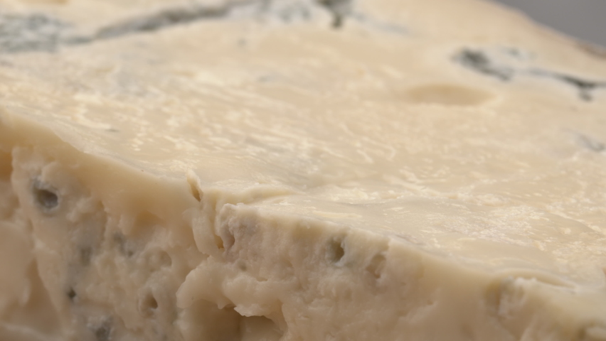 Gorgonzola cheese. Close-up of delicious blue Roquefort cheese. delicious piece of soft brie cheese. Piece of Italian gorgonzola picante. Gorgonzola cheese on wooden board.  Royalty-Free Stock Footage #1075606574