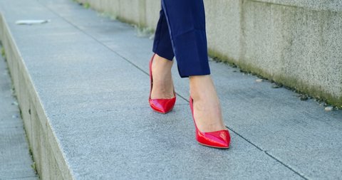 Beautiful Female Legs in Red Shoes are Walking Around the City. Seductive and Sexy. Businesswoman Classic Clothes, Business, Finance, Manager, Secretary, Woman, Remote work, Seduction, USA Close Up 