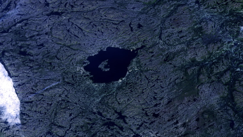Lake and rocks, night to day sunrise animation aerial satellite view of Mistastin lake in Canada, result of asteroid impact. Images furnished by Nasa