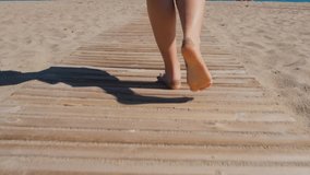 Woman Walking On The Woods At The Beach.
Low angle video clip of a woman walking along a beautiful stretch of white sand beach as the camera gently follows her around her.