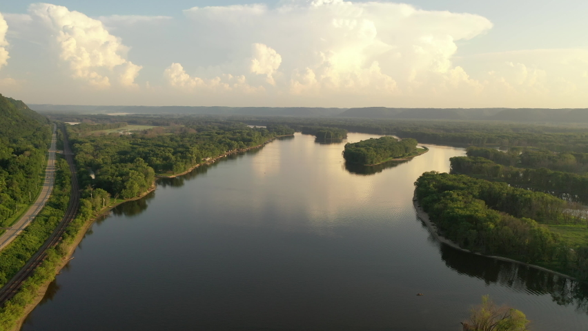 Aerial view of Mississippi river at sunset. Minnesota Wisconsin border, near La Crosse. Summer, beautiful evening landscape, clouds Royalty-Free Stock Footage #1075623980
