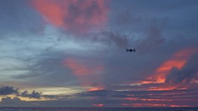 drone shooting stunning sunset at the sea in twilight.
 video 4K. Nature video High quality footage. 
Scene of Colorful red light trough in the sky background.