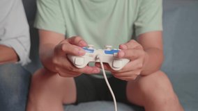 Close Up Hands Of Two Males Holding Joystick And Playing Video Games
