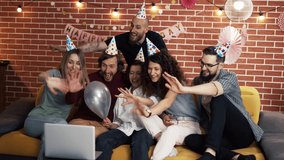Group of people at home celebrating birthday wearing party hats, gasping in surprise, having video call