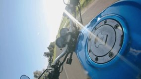 vertical video, POV video of riding a motorcycle on a sunny day