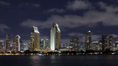 Night timelapse of the San Diego skyline as clouds move through the sky.