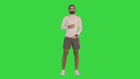 Sporty guy talking on camera on a Green Screen, Chroma Key.