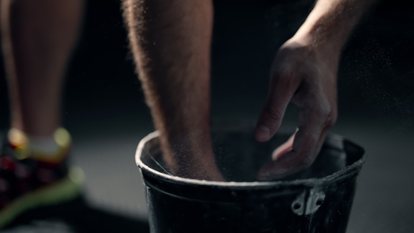 A athlete is rubbing magnesia on hands and clapping. Close up of male boxer hands with talcum powder. A man is preparing for a workout at the gym. Concept of lifestyle health and sports. Slow motion. Royalty-Free Stock Footage #1075642682