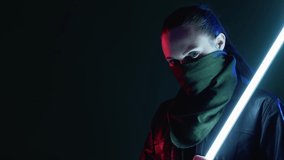 Cyberpunk warrior. Street riot. Apocalypse survivor. Futuristic battle. Red blue neon light confident woman in face buff mask biker jacket with white glowing LED stick at dark night. - Powered by Shutterstock - Get 15% off with code: PIKWIZARD15
