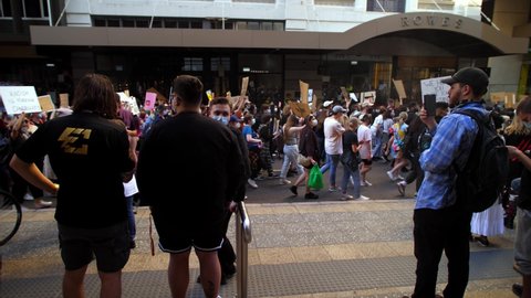 BRISBANE, QUEENSLAND, AUSTRALIA. JUNE 06 2020. Spectators film Black Lives Matter demonstrators.