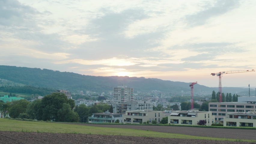 Time lapse Sunset. Clouds with sunbeams over the hills. Switzerland.